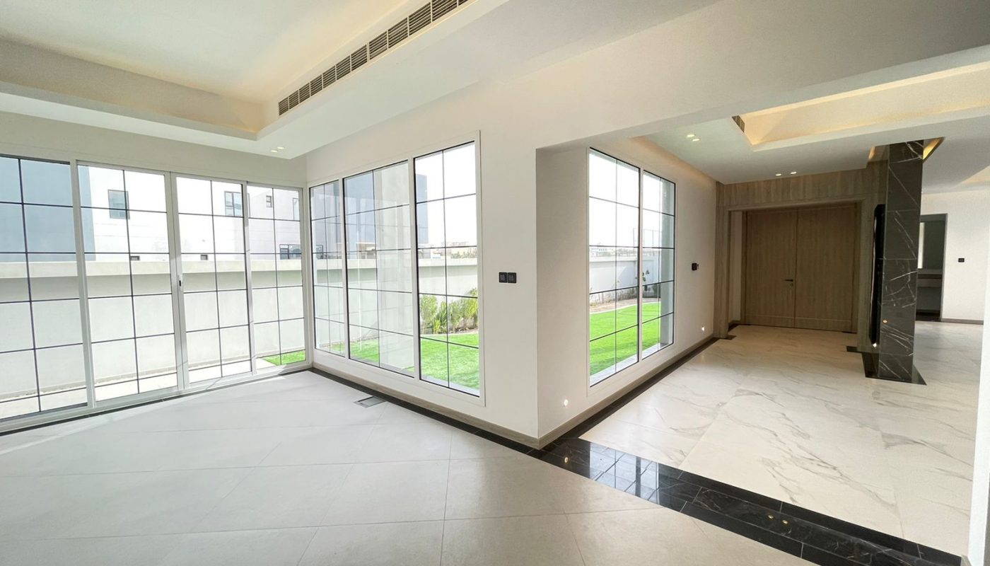 A luxury living room with large windows and marble floors in a 5-bedroom villa.