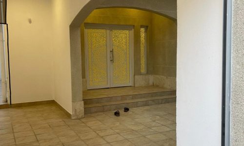 Cozy hallway with a door leading into a house.