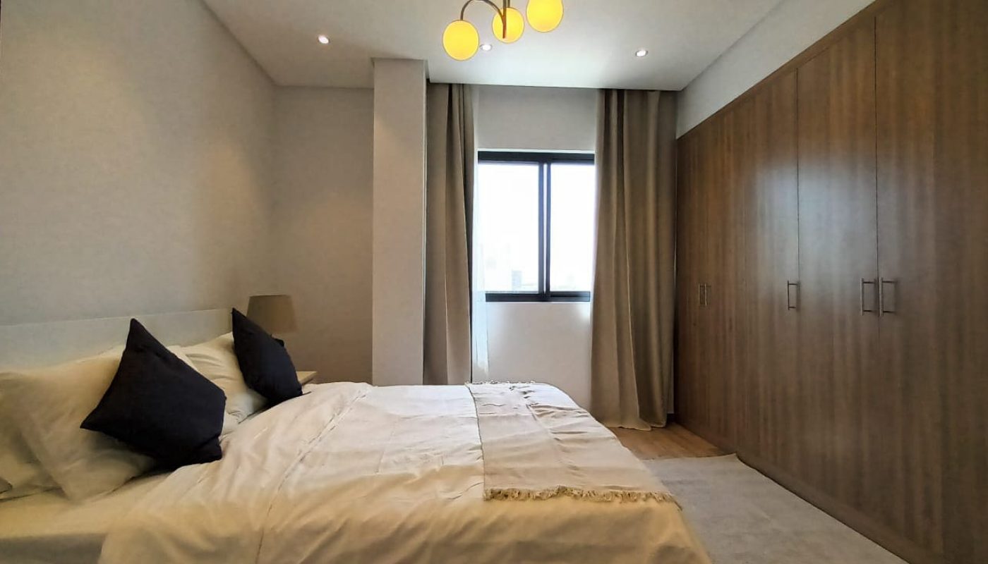 Brand New 3BR Apartment with white bed and wooden cabinets for Rent in Al Janabiyah.