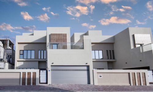 A luxury house with a garage in the middle of the street.