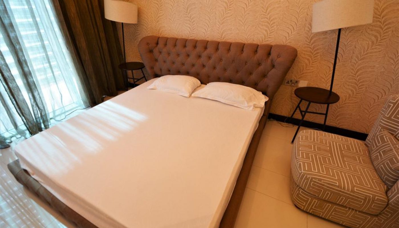 A bed or beds in an exquisite room at Savoy Dubai with a sea view.