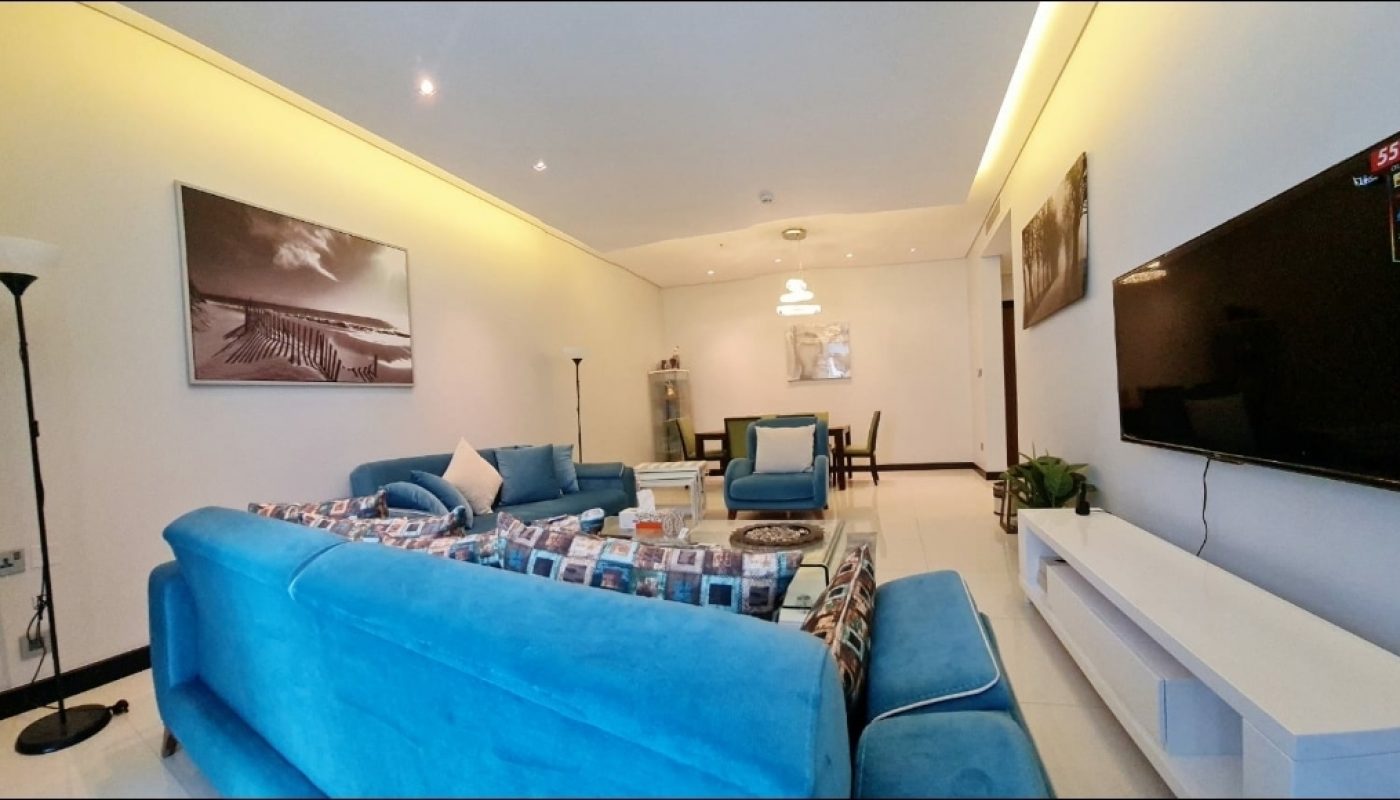 An Amazing living room with blue couches and a tv.