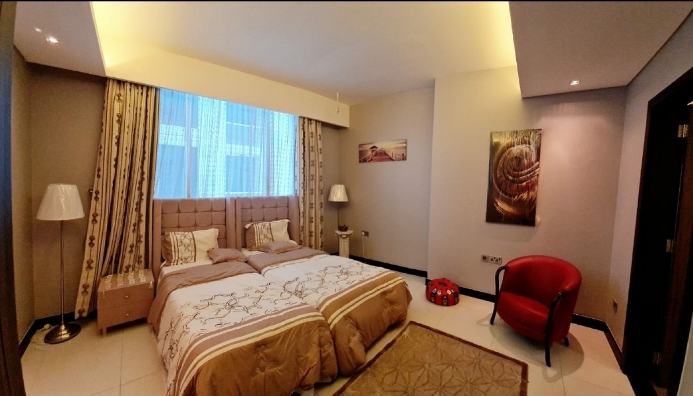 An amazing bedroom with a bed and a bedside table in a great tower.