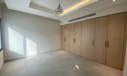 A modern room with wooden cabinets and a ceiling light.