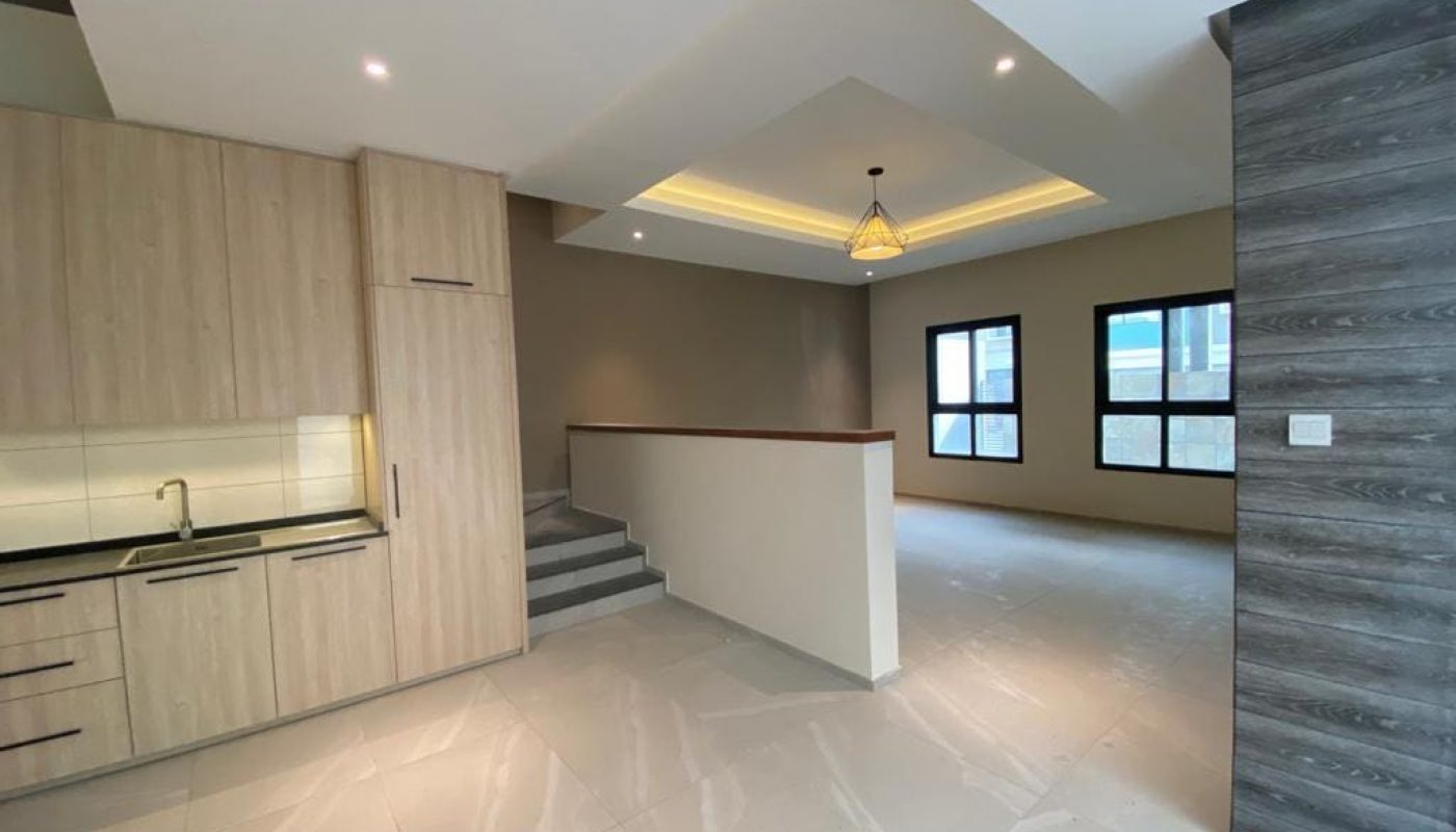 A brand new house with an empty kitchen and living room available for rent.