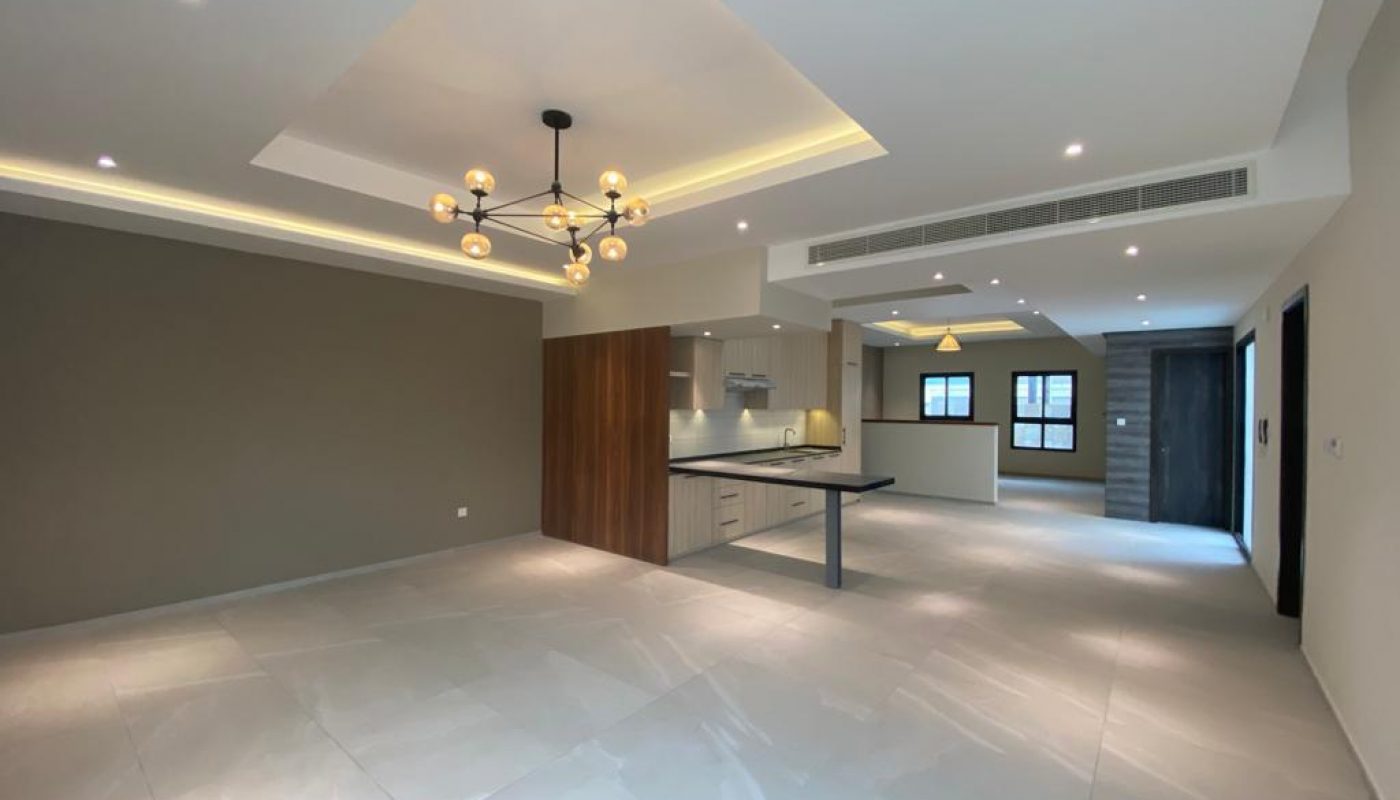 An empty kitchen and living room in a modern BRAND NEW apartment.