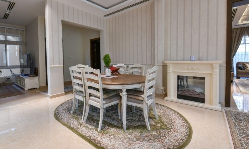 A luxurious living room with a dining table and chairs.