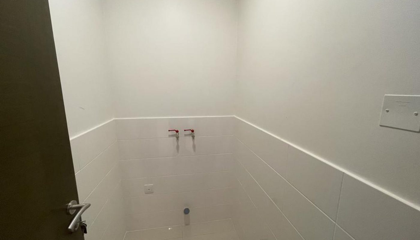 A small white bathroom with a toilet and sink in a glorious apartment for rent at Durrat Marina.