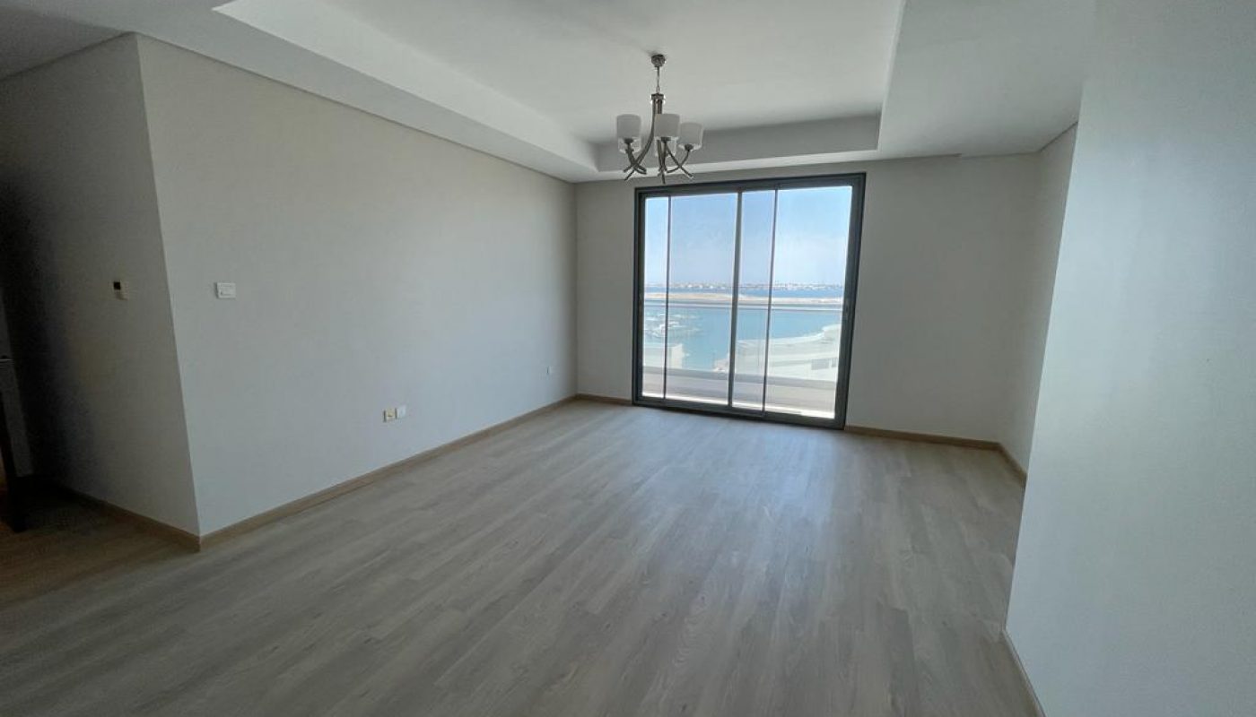 A serene apartment with wooden floors and a breathtaking view of the ocean for rent.