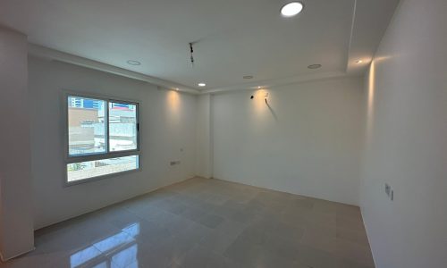 A Sanabis commercial office space available for rent. This empty room features white walls and a window, providing ample natural light.