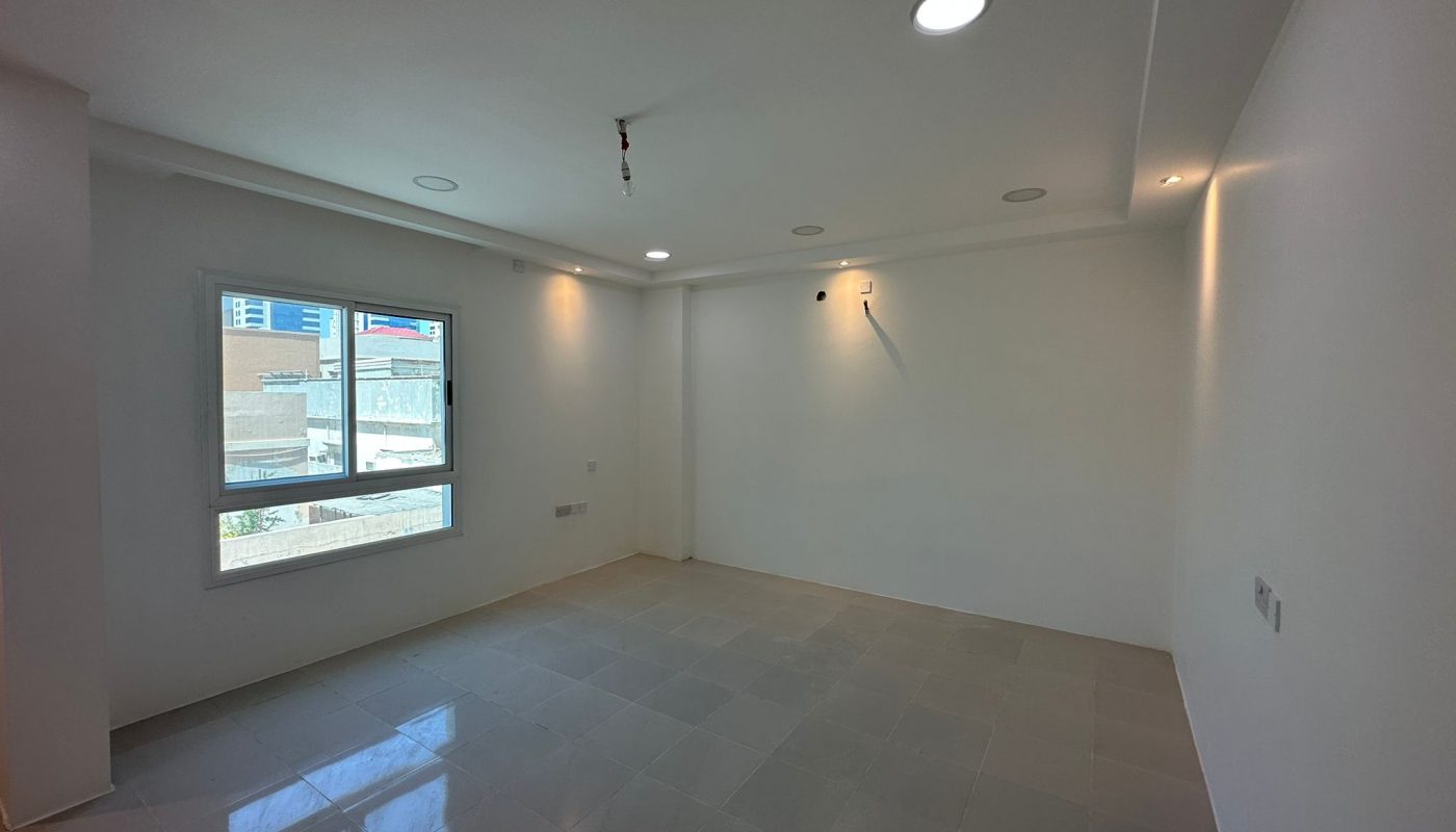 A Sanabis commercial office space available for rent. This empty room features white walls and a window, providing ample natural light.