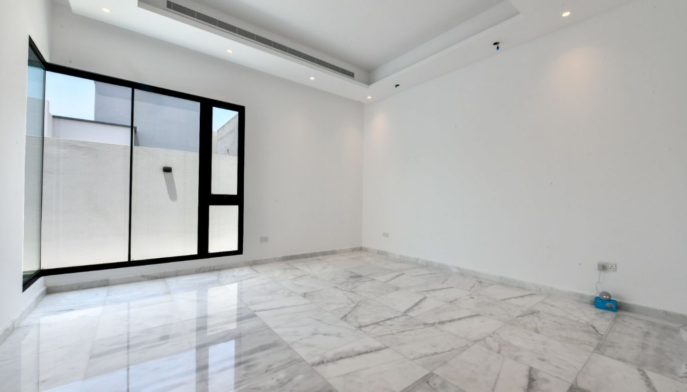 A modern villa with marble floors and a sliding glass door is now available for sale in Janabiyah.