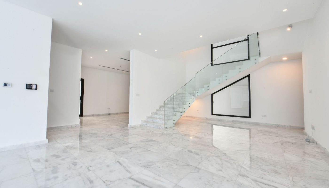 Modern Villa for Sale with marble floors and a staircase.
