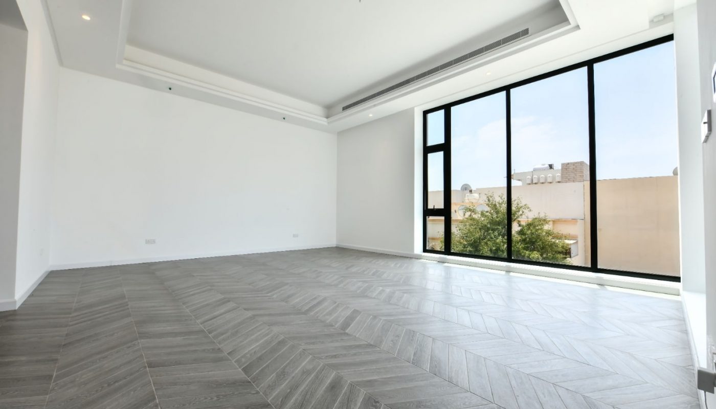 An empty room with large windows.