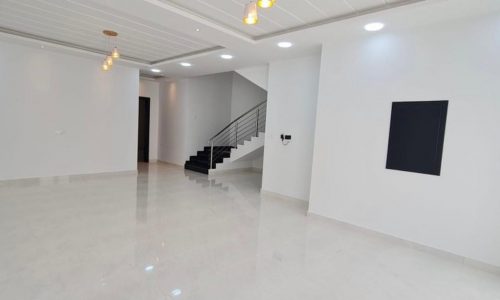 Luxury 4BR Villa with Garden for Sale in Sitra: A large empty room with white walls and white floors.