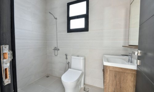 Bathroom with toilet and sink in a luxury 3BR Villa for sale.