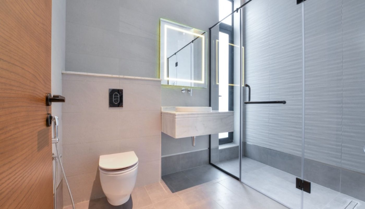 Luxurious villa with modern bathroom featuring a glass shower and toilet, available for sale in Saar.