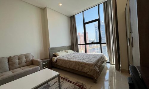 A JUFFAIR dream apartment complete with a luxurious residential towers featuring a comfortable bed, cozy couch, and modern TV.