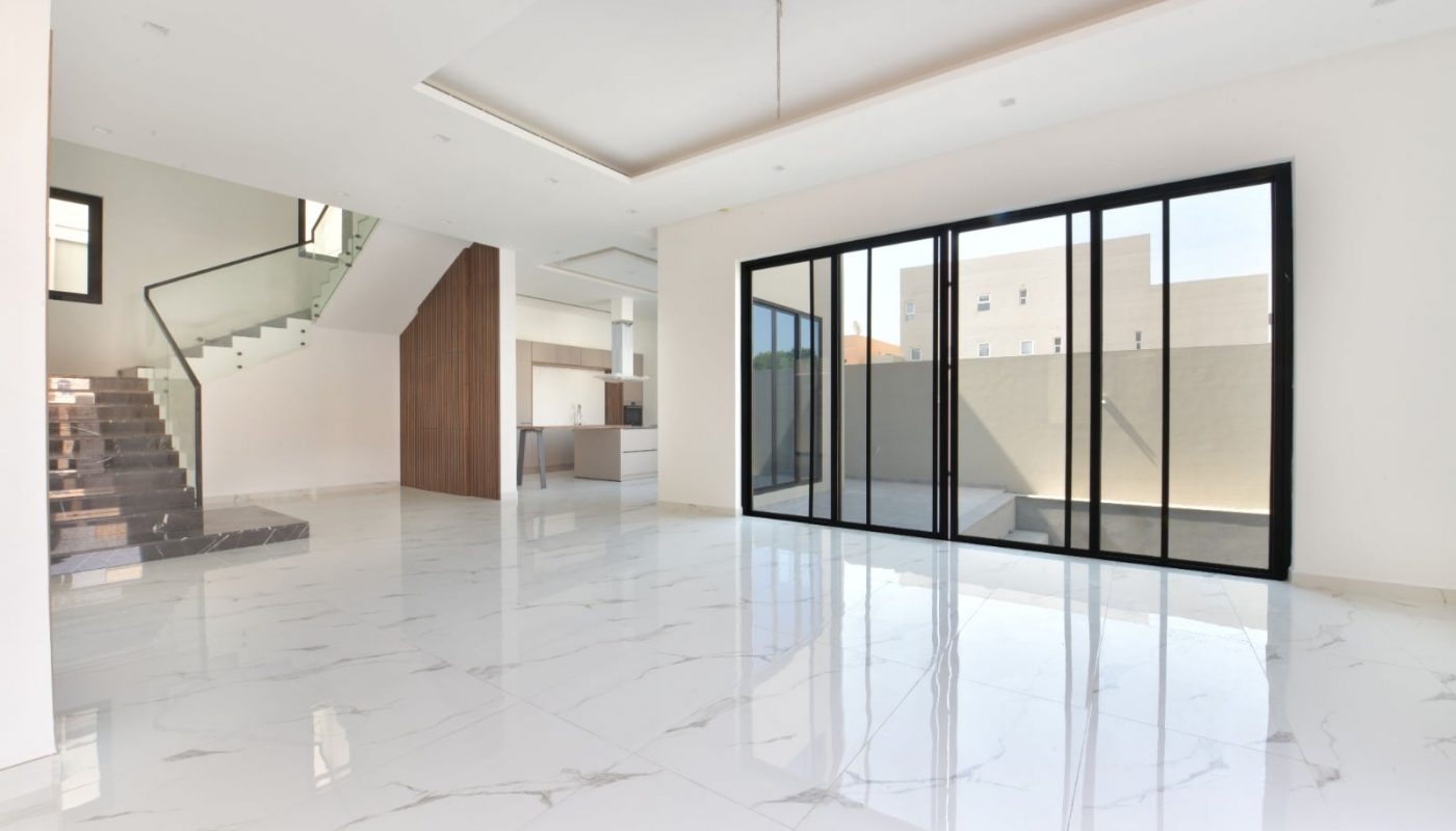 A luxurious villa with glass doors.