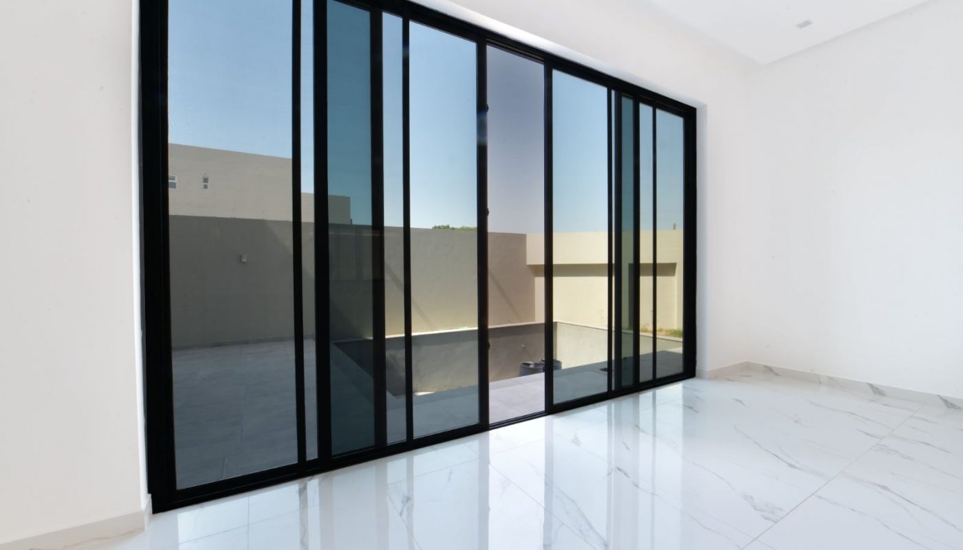 Luxurious villa for sale with sliding glass doors and a white floor.