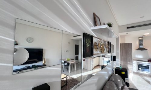 A luxury living room with mirrors and a couch in Juffair.