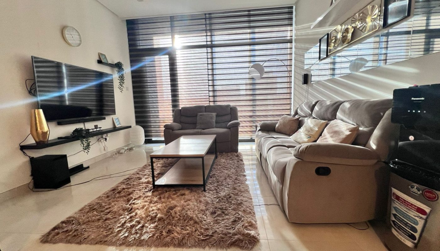 A luxury living room in Juffair with a flat screen TV and a coffee table.