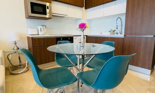 A small kitchen with Auto Draft dining table and chairs.