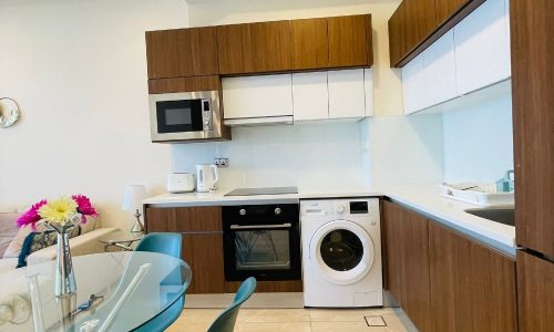 A kitchen with an auto draft washer and dryer in it.