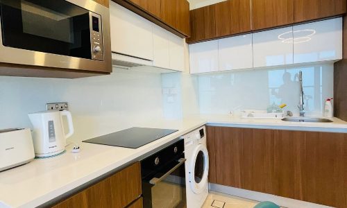 A kitchen with a microwave oven, a washing machine, and an Auto Draft system.