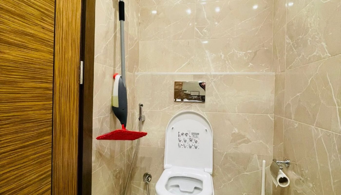 A bathroom with a toilet, a mop, and Auto Draft.