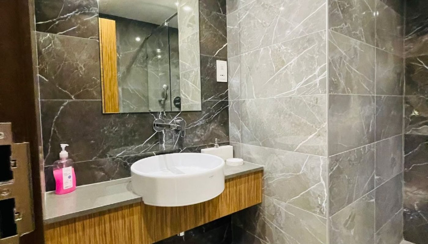 A bathroom with marble walls and an Auto Draft sink.
