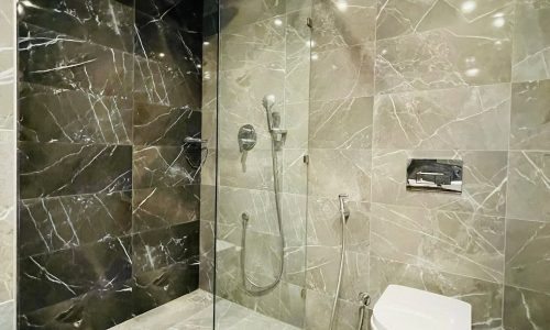 A bathroom with a glass shower stall, a toilet, and Auto Draft.