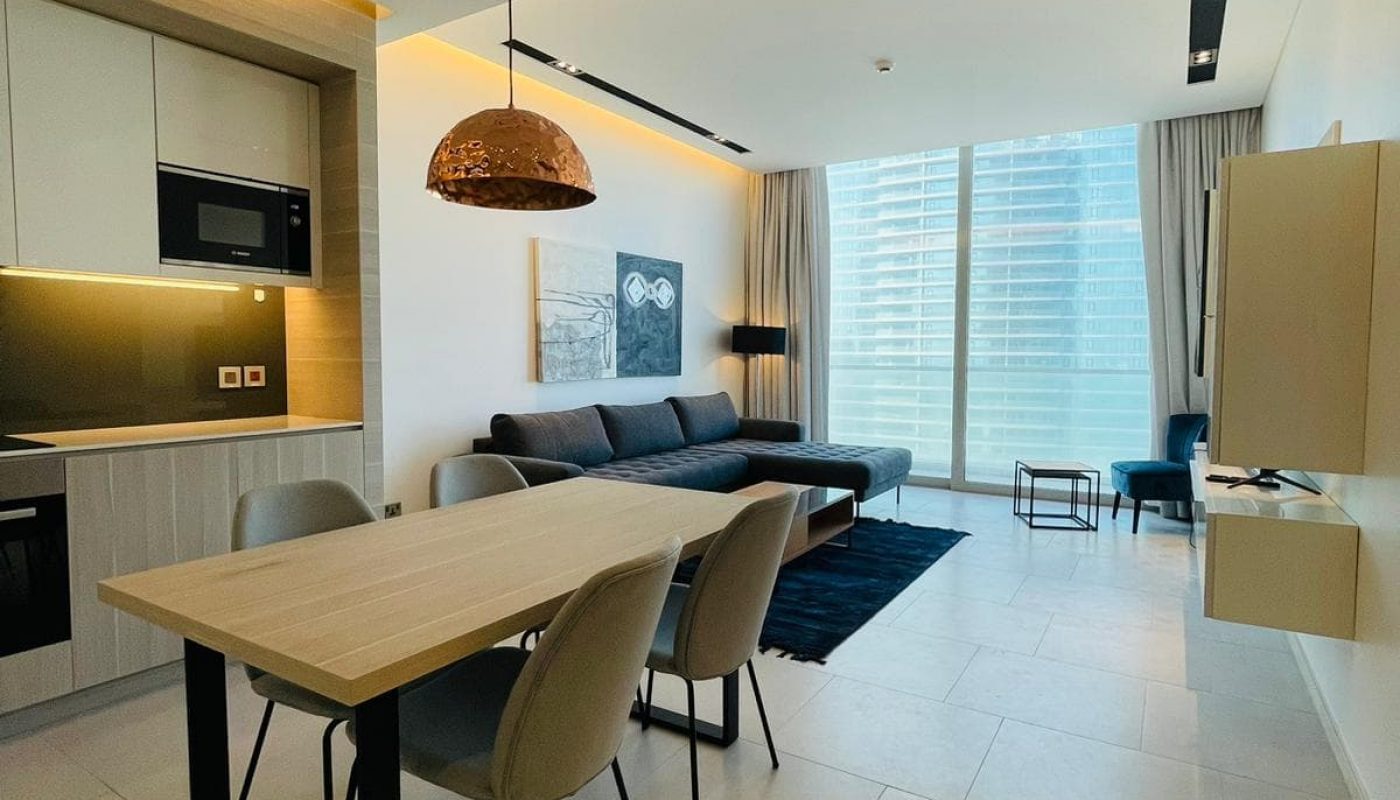 A living room and dining area in a modern apartment.
