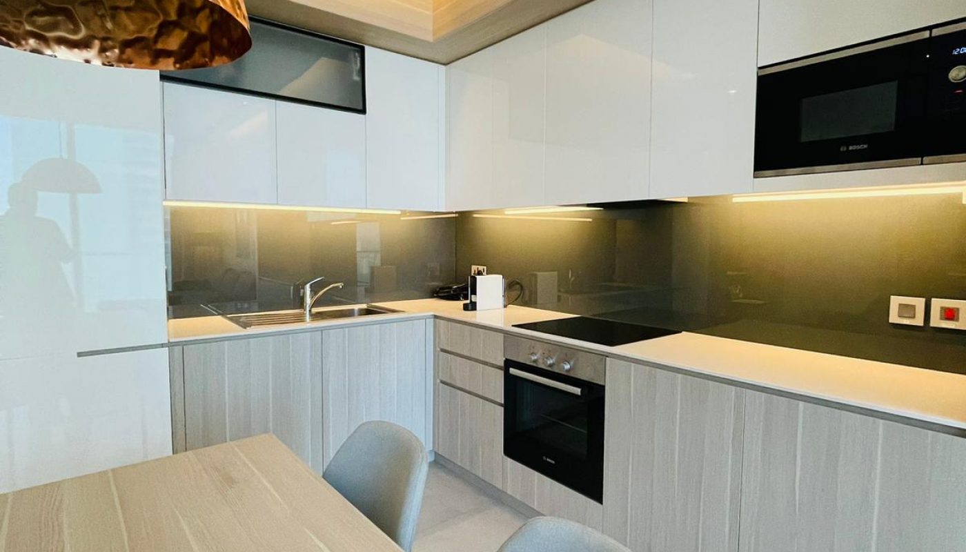A modern kitchen with a wooden table and chairs.