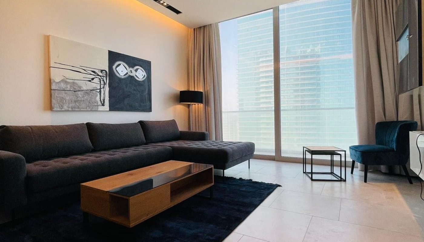 A living room with a view of the ocean.