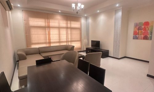 A modern living room with a dining table and chairs.