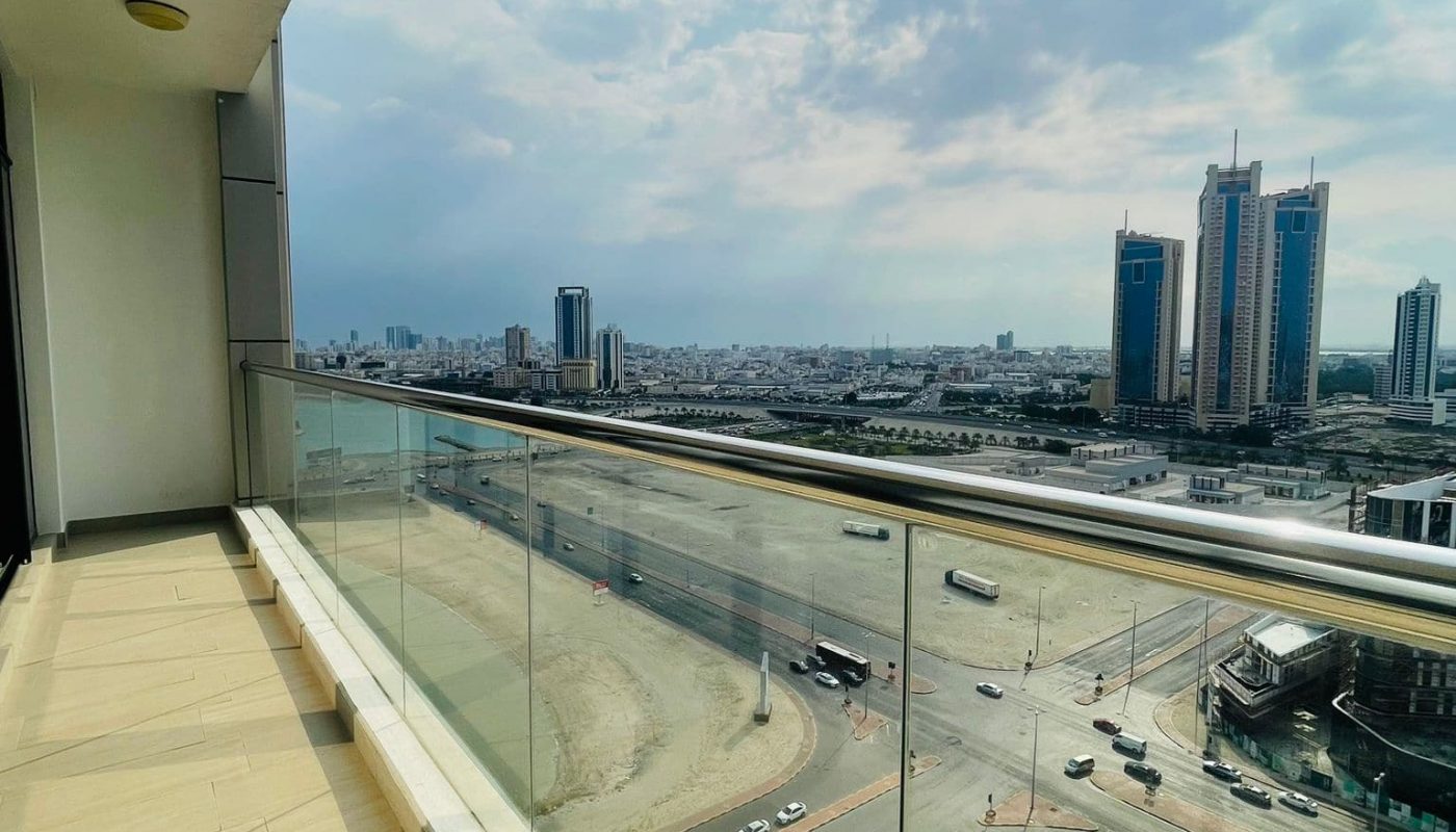 Seef luxury 1 BR apartment with a balcony and city view.