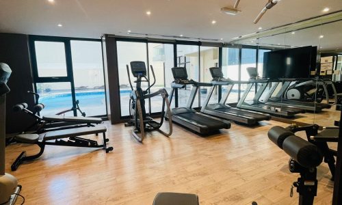 Luxury Seef 1 BR Apartment with a breathtaking view of the ocean and a gym room equipped with tread machines.