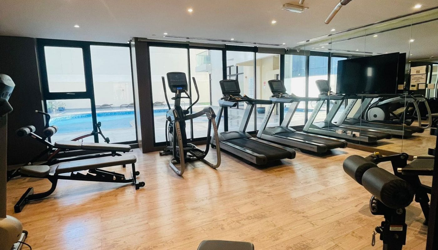 Luxury Seef 1 BR Apartment with a breathtaking view of the ocean and a gym room equipped with tread machines.