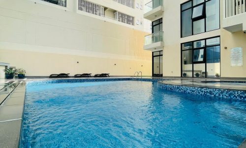 A luxury apartment building with a swimming pool Seef