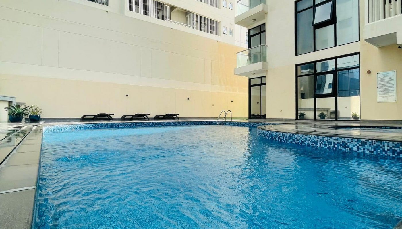 A luxury apartment building with a swimming pool Seef