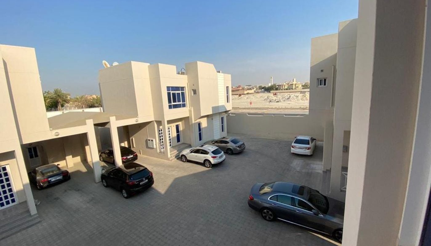 A view of a parking lot with cars parked in it.