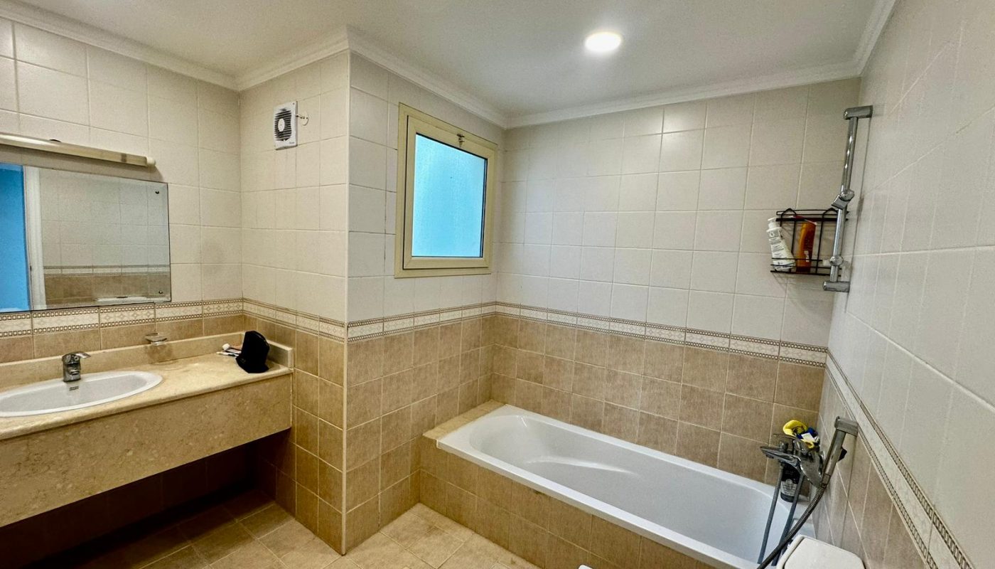 A luxury bathroom with a tub and sink in a private villa.