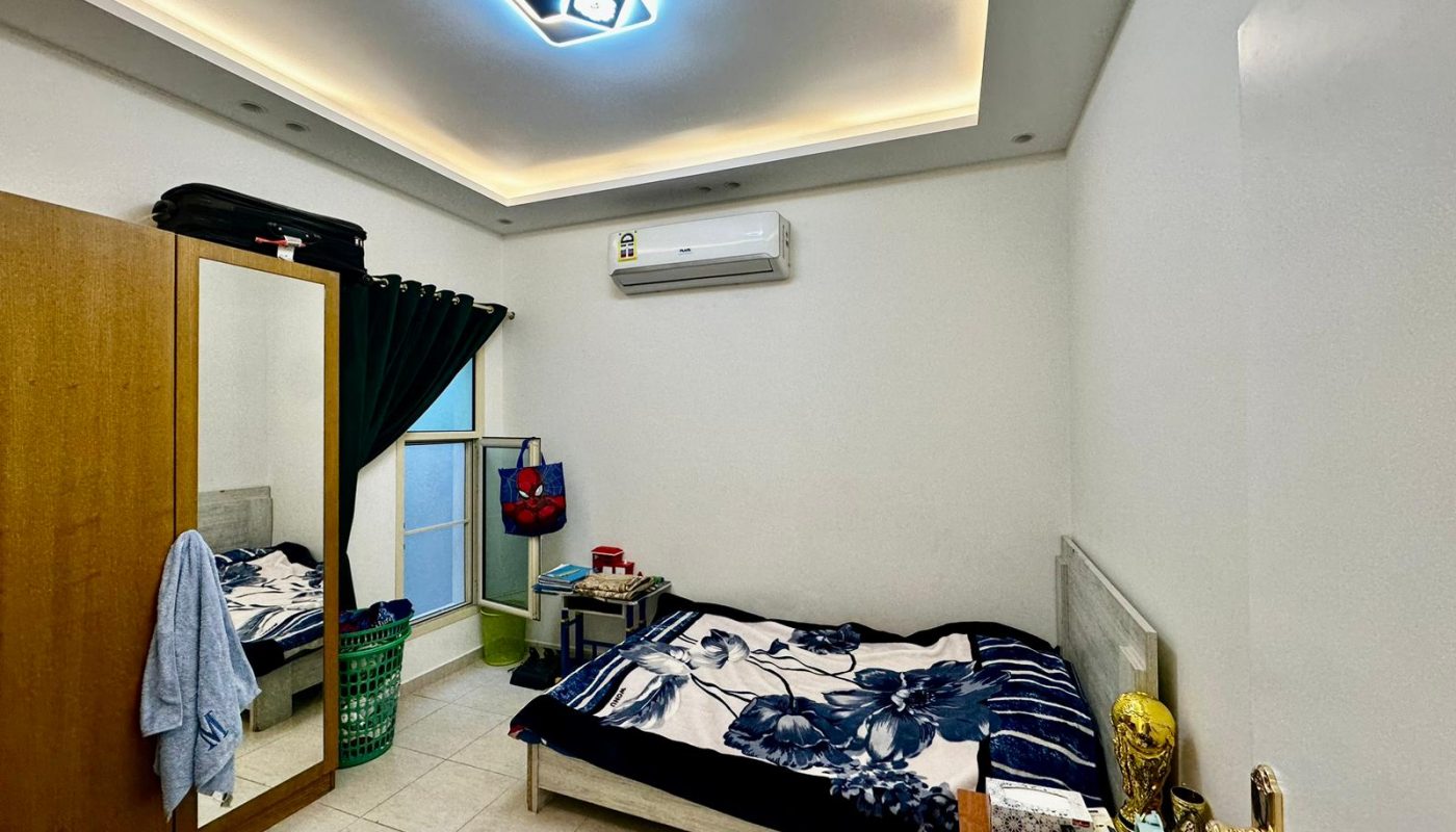 A luxurious room with a comfortable bed and a large mirror.