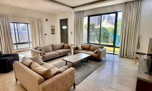 A living room with couches and a flat screen tv.