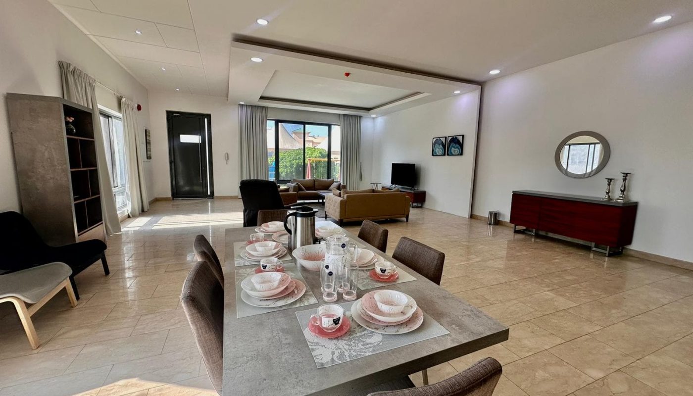 A living room with a dining table and chairs.