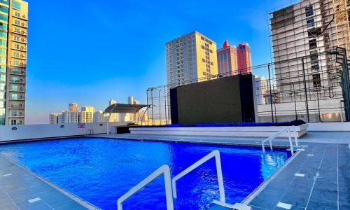 A luxurious apartment with a swimming pool in the middle of a city.