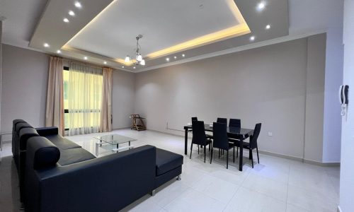 A living room with a dining table and chairs.