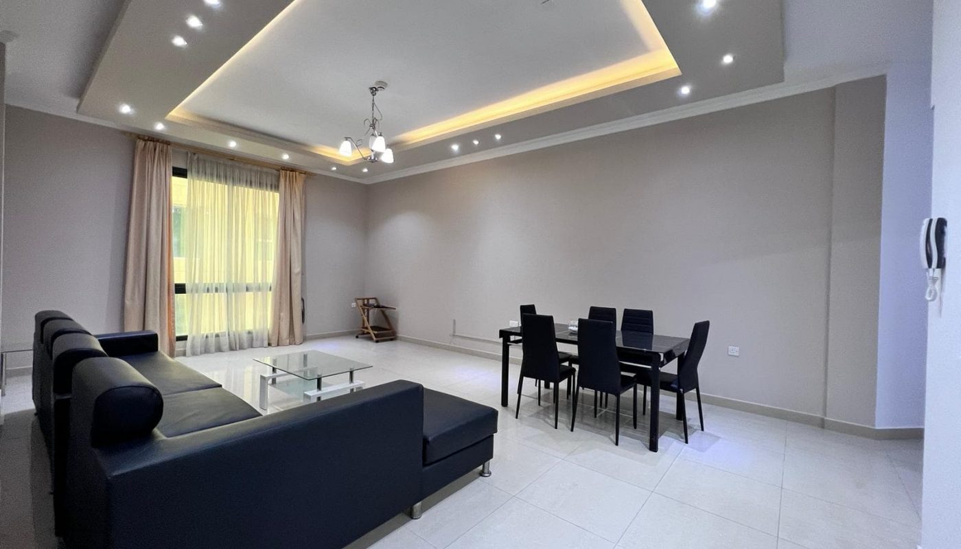 A living room with a dining table and chairs.