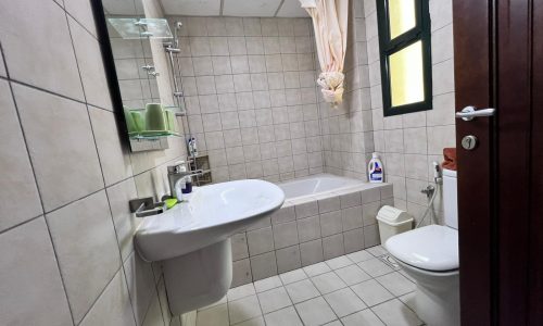 Elevate your living experience in this Juffair bathroom, complete with a toilet, sink, and shower.